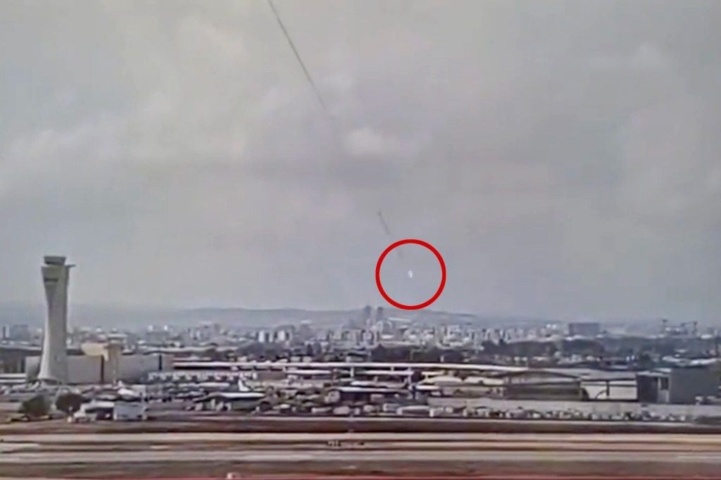 Surveillance footage shows the moment the Houthi missile (circled in red) struck near Ben Gurion Airport in Tel Aviv, Israel.