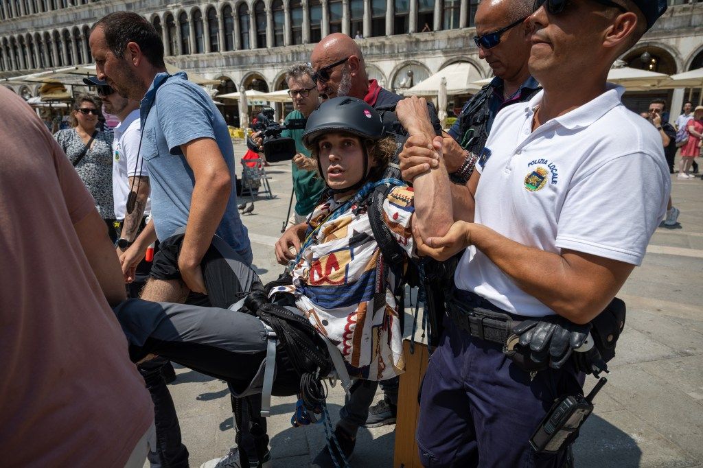 A protester being detained by police in Venice.