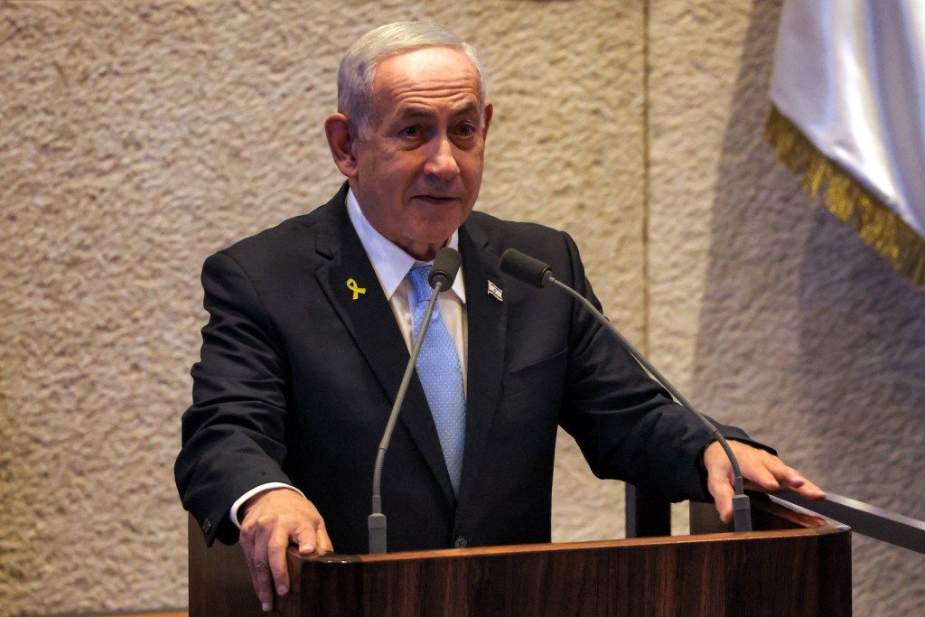 Benjamin Netanyahu speaking at a podium.
