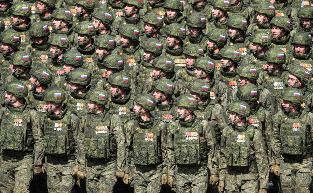Russian soldiers in camouflage uniforms marching in Red Square.