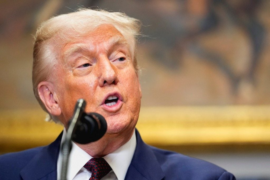 President Trump speaking at a microphone.