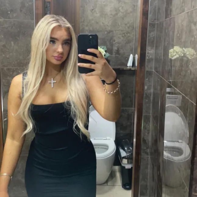 Selfie of Megan Breen in a black dress.