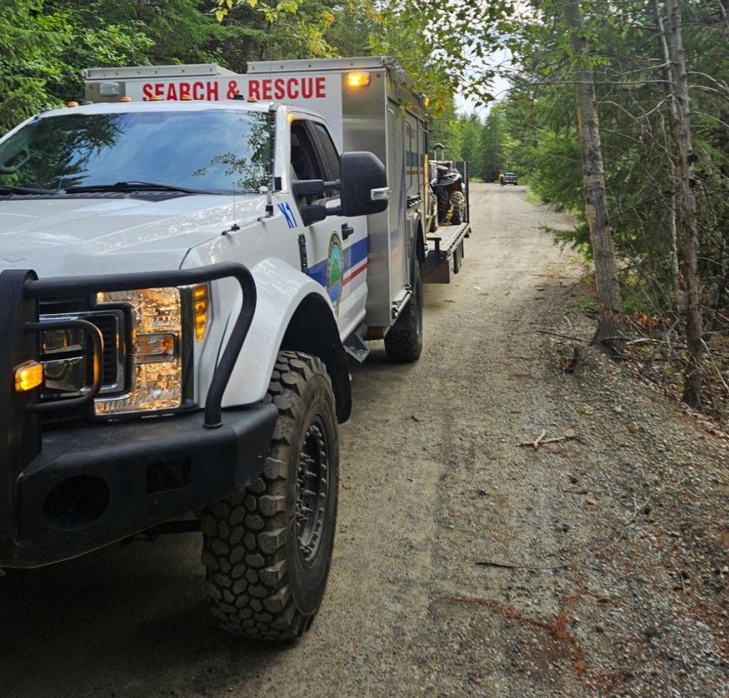 Search and rescue truck on a gravel road.