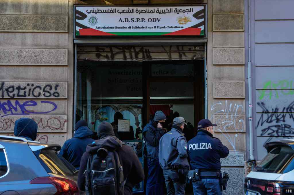 Police officers inspecting a charitable association supporting Palestinian civilians in Milan, Italy.
