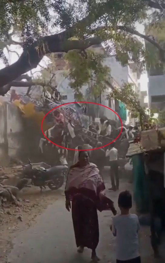 Video grab of crowds rushing to help after a packed fairground swing ride collapsed into a wall at the Maharaj No Melo fair.