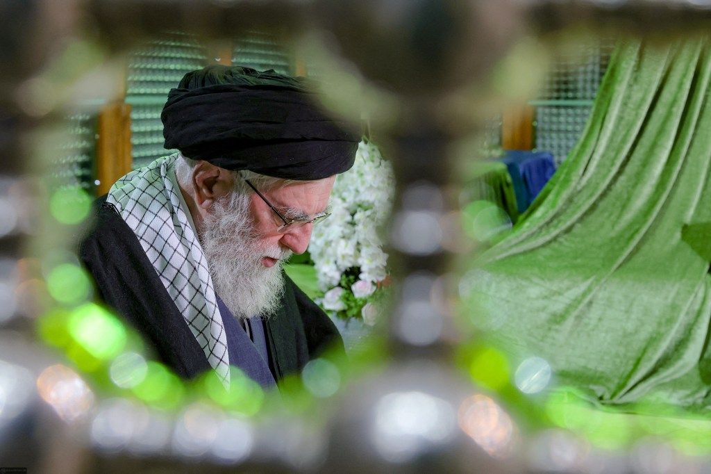 Ayatollah Ali Khamenei praying during a visit to the tomb of Ayatollah Ruhollah Khomeini.