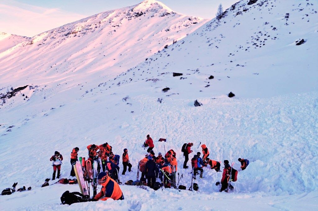 Rescuers search for people after an avalanche in the Salzburg Pongau region of western Austria.