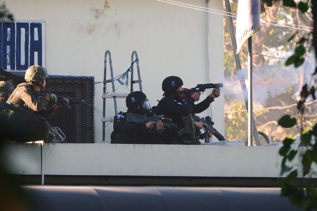 Guatemalan security forces shooting weapons to regain control of a prison.