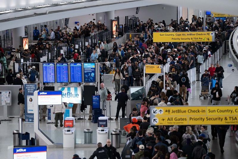 NEW YORK, NEW YORK - MARCH 22: People wait in long TSA security lines at John F. Kennedy International Airport on March 22, 2026 in New York, New York. The travel disruptions continue as hundreds of TSA agents quit or work without pay during a partial government shutdown. U.S. President Donald Trump said ICE agents will be deployed to U.S. airports on Monday, with border czar Tom Homan in charge of the effort. (Photo by Adam Gray/Getty Images)