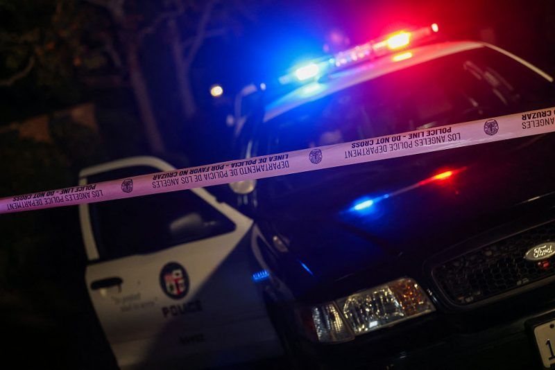 A Los Angeles Police Department patrol car is seen behind police tape blocking the access to a house in the Brentwood neighborhood of Los Angeles, California, on December 14, 2025. Two people were found dead at the Southern California mansion of director and actor Rob Reiner on Sunday, local broadcaster NBCLA and other media outlets reported. The LA Fire Department told NBC a man and a woman, approximately 78 and 68 years old, were found deceased inside. (Photo by Michael Tran / AFP via Getty Images)