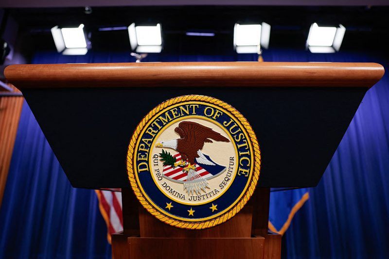 The seal of the US Department of Justice is displayed on a podium before Acting Attorney General Todd Blanche holds a news conference about the Trump administration's anti-fraud efforts at the Department of Justice headquarters in Washington, DC, on April 7, 2026. (Photo by Kent Nishimura / AFP via Getty Images)