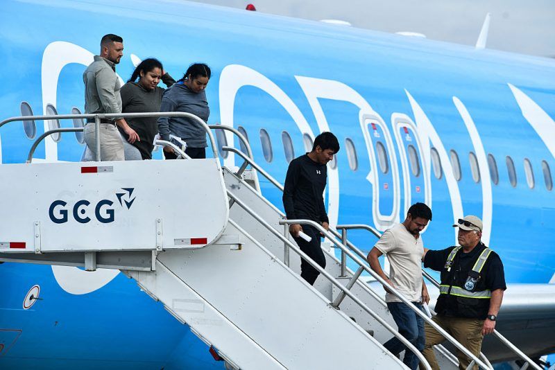 Migrants deported from the United States get off an airliner at the runway of the Juan Santamaria International Airport in Alajuela, Costa Rica, on April 11, 2026. US on April 11, 2026, deported 25 foreign migrants to Costa Ricathe first under an agreement that allows it to send that number of deportees from third countries to the Central American nation each week while their status is being resolved. (Photo by Ezequiel BECERRA / AFP via Getty Images)