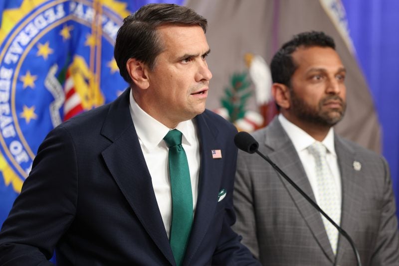 WASHINGTON, DC - APRIL 27: Acting Attorney General Todd Blanche speaks as FBI Director Kash Patel listens at a press conference at the Department of Justice on April 27, 2026 in Washington, DC. The officials took questions from the press and gave updates about the case against Cole Tomas Allen, the suspect in the shooting at the White House Correspondents Dinner. (Photo by Tasos Katopodis/Getty Images)