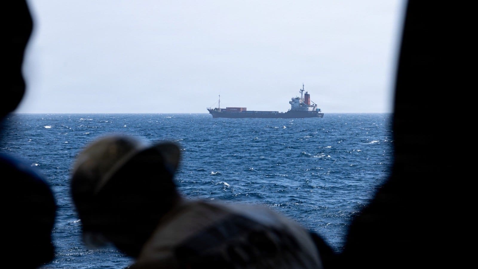 U.S. Marines monitor a commercial vessel during blockade-related maritime operations near Iranian ports.