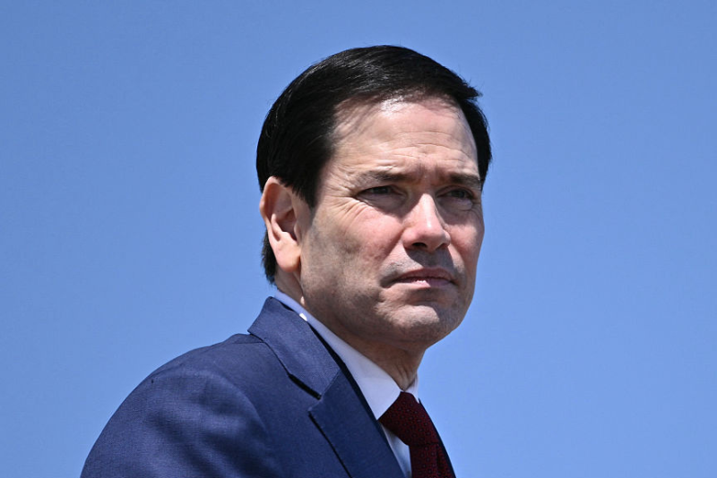 US Secretary of State Marco Rubio boards Air Force One at Joint Base Andrews, Maryland, on May 12, 2026 as he departs for a 3-day state visit to China. President Trump said Monday he was ready to discuss US arms sales to Taiwan during his visit this week to Beijing, as he suggested his personal chemistry with counterpart Xi Jinping would prevent a Chinese invasion of the island. Trump will bring along top US executives for a trip expected to focus heavily on the US president's hopes to ramp up trade. (Photo by Brendan SMIALOWSKI / AFP via Getty Images)