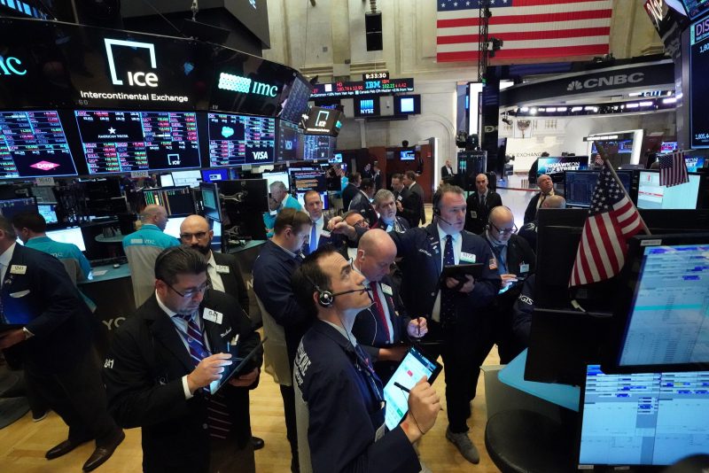 Traders work on the floor at the opening bell of the Dow Industrial Average at the New York Stock Exchange on March 18, 2020 in New York. - Wall Street stocks resumed their downward slide early Wednesday as the economic toll mounts from the rapid near-shutdown of key industrial and services sectors.About 15 minutes into trading, the Dow Jones Industrial Average stood at 20,040.66, down around 1,200 points or 5.6 percent. (Photo by Bryan R. Smith / AFP) (Photo by BRYAN R. SMITH/AFP via Getty Images)