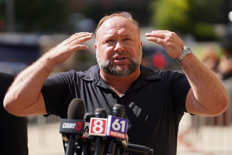 WATERBURY, CONNECTICUT - SEPTEMBER 21: InfoWars founder Alex Jones speaks to the media outside Waterbury Superior Court during his trial on September 21, 2022 in Waterbury, Connecticut. Jones is being sued by several victims' families for causing emotional and psychological harm after they lost their children in the Sandy Hook massacre. A Texas jury last month ordered Jones to pay $49.3 million to the parents of 6-year-old Jesse Lewis, one of 26 students and teachers killed in the shooting in Newtown, Connecticut. (Photo by Joe Buglewicz/Getty Images)