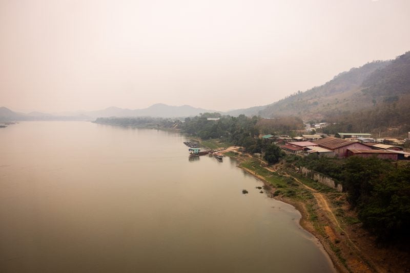 LUANG PRABANG, LAOS - APRIL 09: A rural Lao village is seen from the window of the China-Laos Railway on April 09, 2024 in Luang Prabang, Laos. The China-Laos railway, a key project of China's Belt and Road Initiative, is a high-speed railway connecting Kunming, the capital of China's Yunnan province, to Vientiane, the capital of Laos. This railway is the biggest public infrastructure project ever undertaken by Laos, with a total length of 1,035 kilometers and a cost of US$5.9 billion, which is equivalent to around one-third of Laos' gross domestic product in 2019. The railway is dedicated to both passenger and freight traffic services, creating a new link between Laos and China, the former's neighbor and closest partner. The Laos section of the railway is part of a vision to build a Pan-Asia railway that will ultimately connect China, Laos, Thailand, Malaysia, and Singapore, improving the efficiency of goods movement for export-driven economies along the route, opening up travel and extending China's influence deep into Southeast Asia. (Photo by Lauren DeCicca/Getty Images)