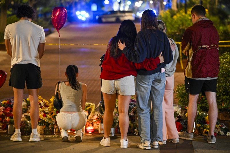 TALLAHASSEE, FLORIDA - APRIL 17: Students hold a vigil near the scene of a shooting near the Florida State University student center on April 17, 2025 in Tallahassee, Florida. According to reports, two people were killed and several others injured when the alleged shooter, believed to be a current student and the son of a Leon County sheriff deputy, opened fire on the university main campus. (Photo by Miguel J. Rodriguez Carrillo/Getty Images)
