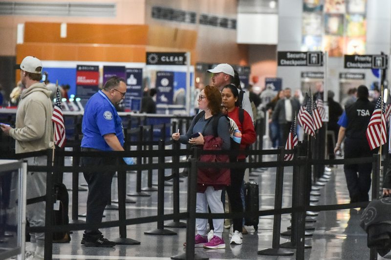 Travelers make their way through a security line at Boston Logan International Airport in Boston, Massachusetts on November 10, 2025. The US Senate took a major step on November 9 toward ending the longest government shutdown in American history when it cleared the way for a formal debate on a motion to resume funding to federal agencies. The deal between Democratic and Republican senators, just the first step to halting the shutdown, came as authorities warned US air travel could soon "slow to a trickle" as thousands more flights were cancelled or delayed over the weekend. (Photo by Joseph Prezioso / AFP) (Photo by JOSEPH PREZIOSO/AFP via Getty Images)