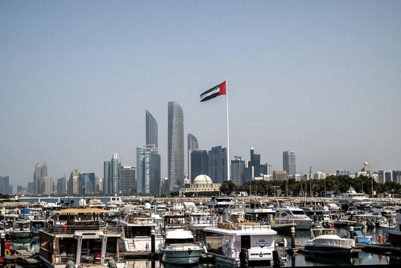 The United Arab Emirates flag flutters against the backdrop of the Abu Dhabi Skyline following a reported Iranian strike on March 1, 2026. Iran's retaliatory missile and drone campaign in the Gulf has killed three people and wounded 58 in the United Arab Emirates since it began, Emirati authorities said on March 1, the day after the US and Israel launched a nationwaide attack on Iran killing its supreme leader. (Photo by Ryan Lim / AFP via Getty Images)