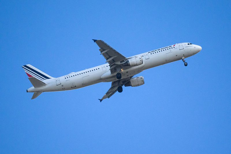 An airbus A321 aircraft of Air France flies over Nantes, western France, on April 13, 2026. (Photo by Loic VENANCE / AFP via Getty Images)