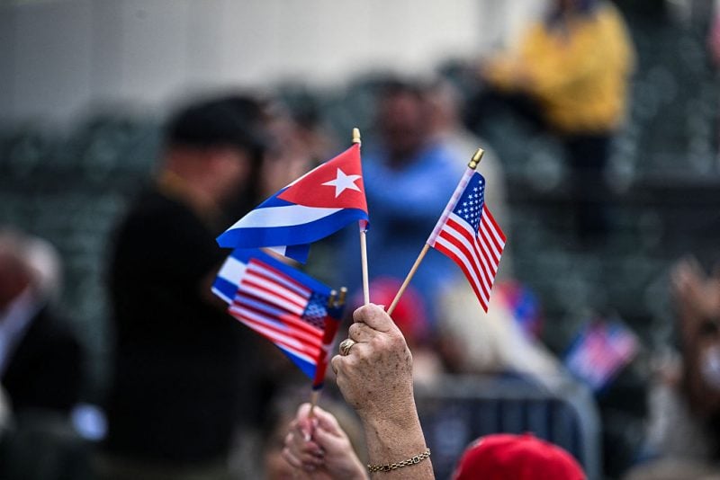 A person waves US and Cuban flags during a "Free Cuba" rally in Miami, Florida, on April 26, 2026, to call for the departure of the Castros and the Communist Party from power in Cuba. (Photo by CHANDAN KHANNA / AFP via Getty Images)