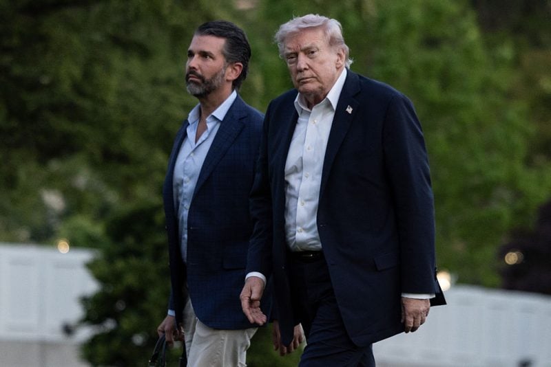 WASHINGTON, DC - MAY 03: President Donald Trump, with son Donald Trump Jr., walks across the South Lawn upon returning to the White House from Florida on May 3, 2026 in Washington, DC. (Photo by Anna Rose Layden/Getty Images)