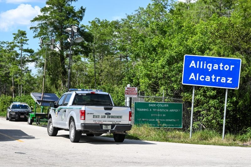 A Florida State Law Enforcement vehicle is seen driving into the immigrant detention center known as "Alligator Alcatraz" at the Dade-Collier Training and Transition Airport in Ochopee, Florida, on May 8, 2026. Republican Florida Governor Ron DeSantis announced during a press conference on May 7, 2026, that Florida's Everglades detention center was "always meant to be temporary" as the state moved toward shutting down "Alligator Alcatraz" after processing roughly 22,000 detainees. (Photo by CHANDAN KHANNA / AFP via Getty Images)