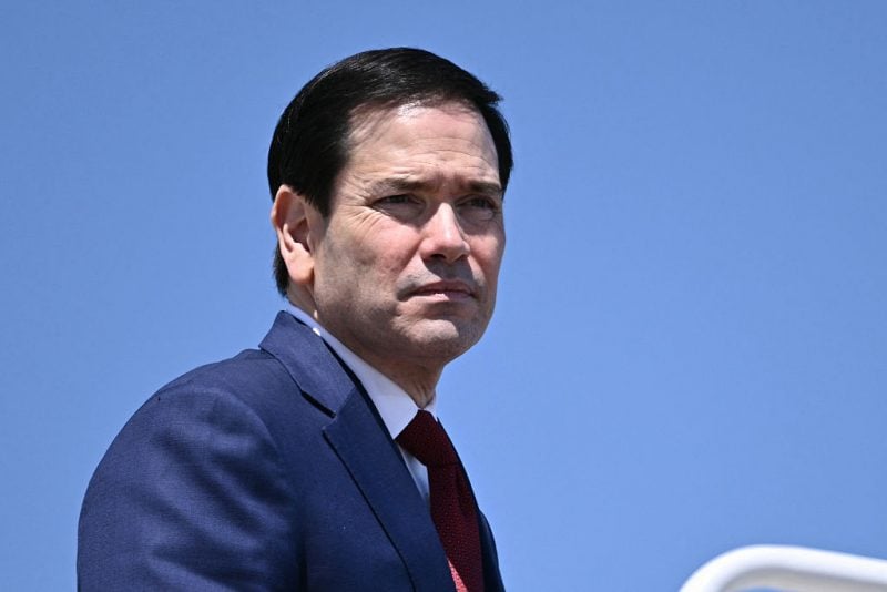 US Secretary of State Marco Rubio boards Air Force One at Joint Base Andrews, Maryland, on May 12, 2026 as he departs for a 3-day state visit to China. President Trump said Monday he was ready to discuss US arms sales to Taiwan during his visit this week to Beijing, as he suggested his personal chemistry with counterpart Xi Jinping would prevent a Chinese invasion of the island. Trump will bring along top US executives for a trip expected to focus heavily on the US president's hopes to ramp up trade. (Photo by Brendan SMIALOWSKI / AFP via Getty Images)