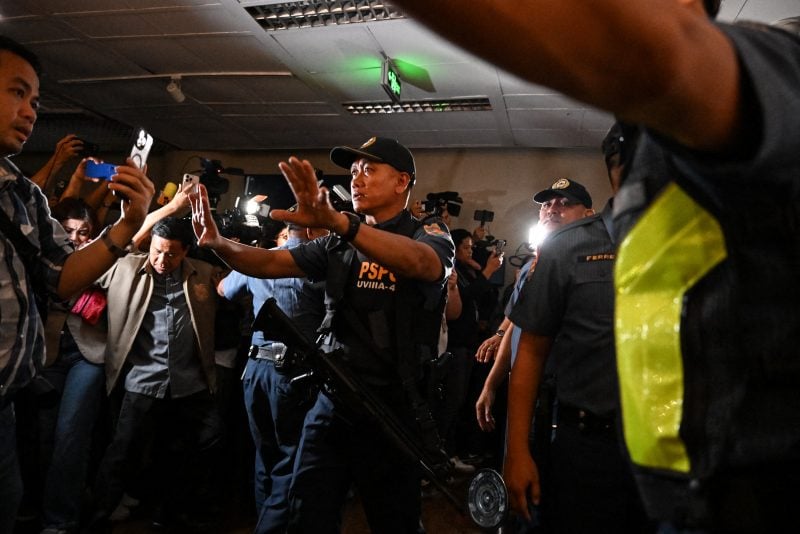 Police personnel arrive as people react to the gunshots heard inside the Senate of the Philippines in Pasay, Metro Manila on May 13, 2026. Multiple gunshots were heard late on May 13 inside the Philippine Senate, where a senator wanted by the International Criminal Court has sought refuge, AFP journalists said. (Photo by Jam STA ROSA / AFP via Getty Images)