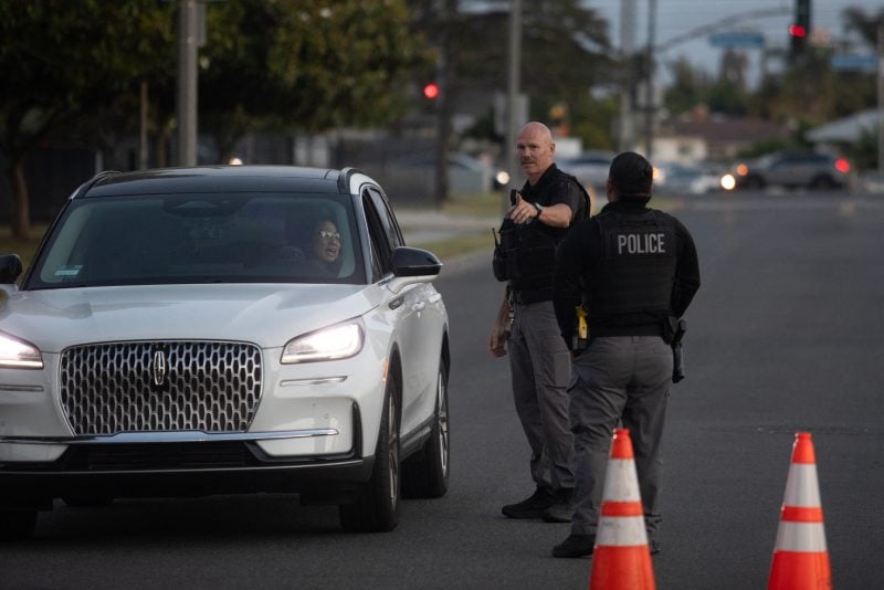 Garden Grove police direct evacuees towards a shelter after a chemical leak from a large storage tank threatened residents in Garden Grove, California on May 22, 2026. Tens of thousands of people were ordered to leave their homes in California Friday after a huge chemical tank began leaking, with warnings it might blow up, sending toxic fumes over a heavily populated area. (Photo by Blake Fagan / AFP via Getty Images)
