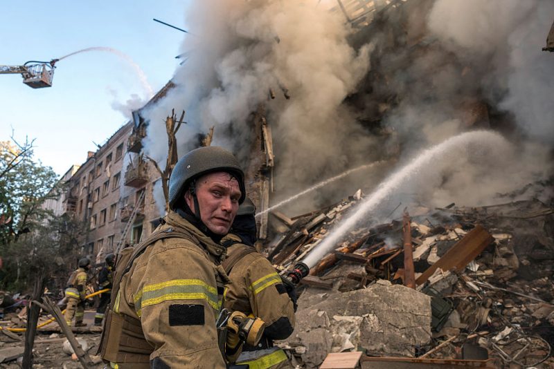 TOPSHOT - Firefighters work to extinguish a fire at the site of a heavily damaged building following Russian strikes to the Ukrainian capital in Kyiv on May 24, 2026, amid the Russian invasion of Ukraine. A large ballistic missile attack pounded Kyiv early on Sunday, authorities said, wounding at least five people after Moscow threatened retaliation for strikes in Russian-occupied eastern Ukraine. (Photo by Vladyslav MUSIENKO / AFP via Getty Images)