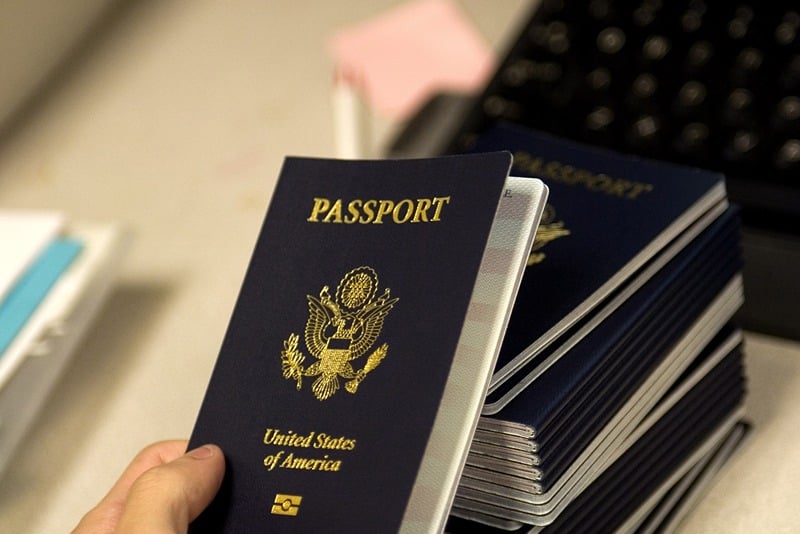 (FILES) A US government official with the State Department's Passport Services reaches for a new blank US Passport with an embedded electronic chip to begin the process of entering personal data and the photograph of an applicant 14 June 2007 at the Passport Services office in Washington, DC. US Senator Joe Lieberman, a senior Washington hawk, on May 6, 2010 proposed a law on stripping citizenship from Americans deemed to have joined the "enemy." They "should no longer be entitled to the rights and privileges of American citizens," Lieberman said. The proposal comes days after the botched Ne York car bomb attack, allegedly by a naturalized US citizen born in Pakistan.  FILES/AFP PHOTO/Paul J. Richards (Photo credit should read PAUL J. RICHARDS/AFP via Getty Images)