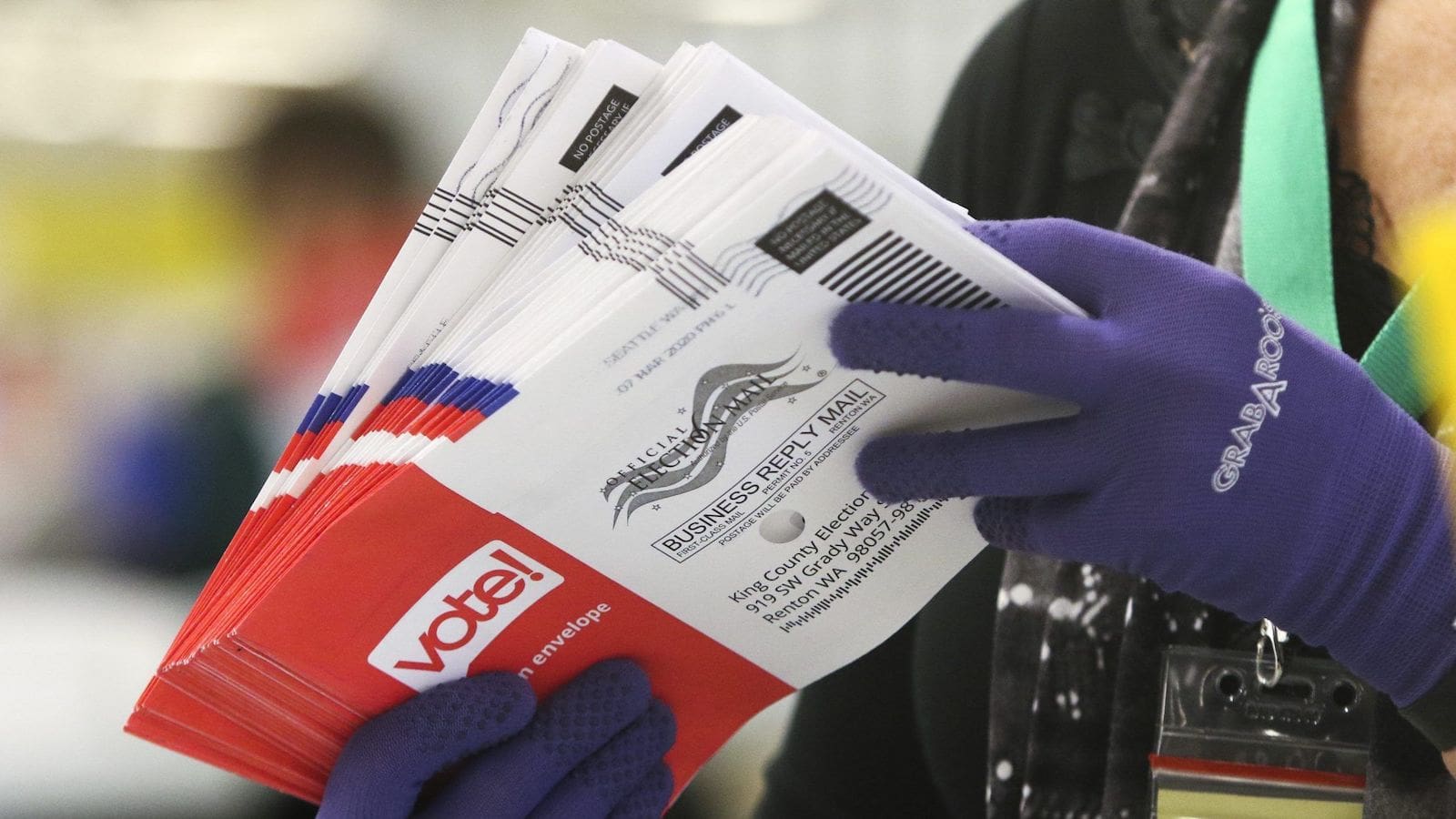 Election ballots being handled by an election worker.