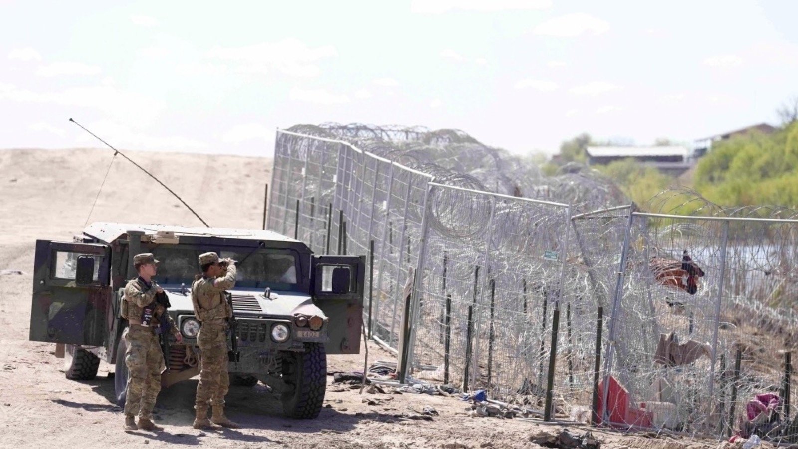 Texas border barrier and Texas Military Department personnel near the southern border