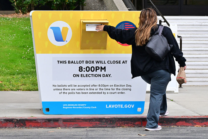 A voter drops off their ballot in a ballot drop box at the Los Angeles County Registrar during early voting in the state's primary election in Norwalk, California, on June 1, 2026. California will hold its primary election on June 2. In the gubernatorial race, the top two finishers, regardless of party, will advance to the general election. (Photo by Frederic J. BROWN / AFP via Getty Images)