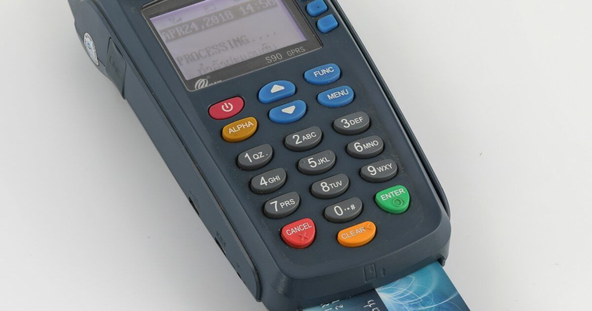 Credit card payment terminal for a ProCoinNews article about Alchemy AgentCard and Visa Intelligent Commerce.