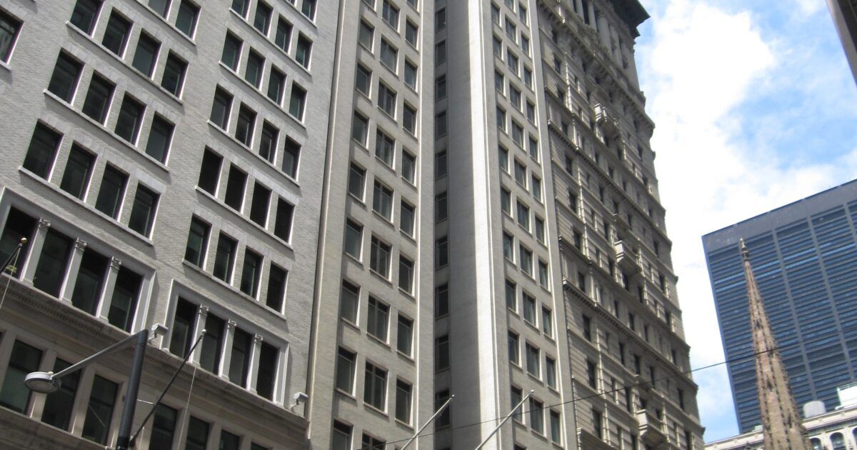 American Express building for a ProCoinNews article about stablecoin and blockchain partnerships.