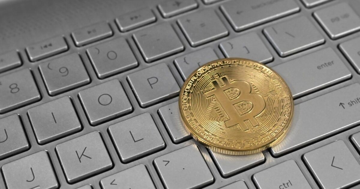Bitcoin on a laptop keyboard for a Coinbase and Hyperliquid USDC treasury wallet story.