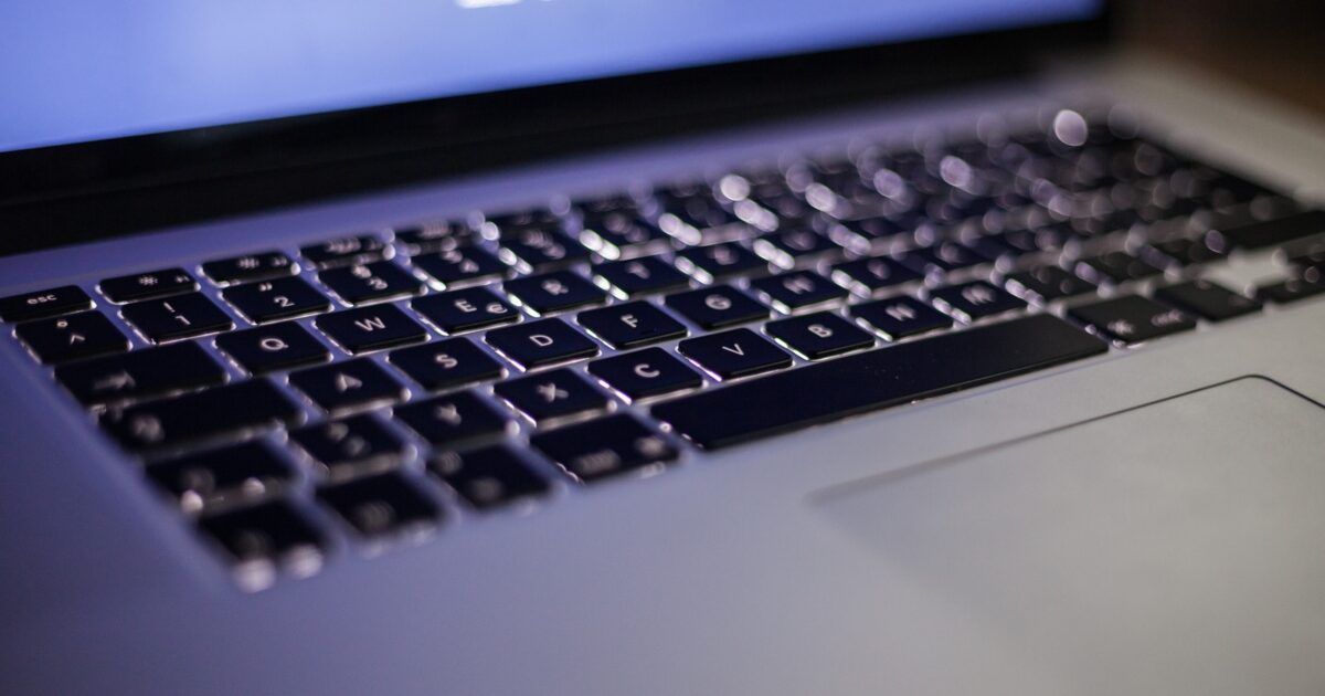 Backlit laptop keyboard for a ProCoinNews article about the SecondFi Cardano wallet exploit.