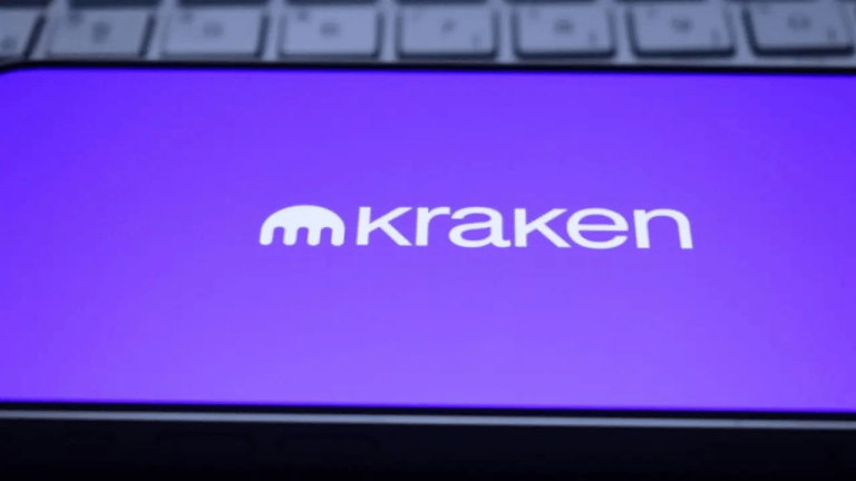 Kraken logo on a smartphone and resting on a keyboard.