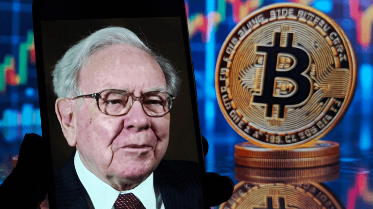 Warren Buffet shown on a smartphone with bitcoin in the backdrop.