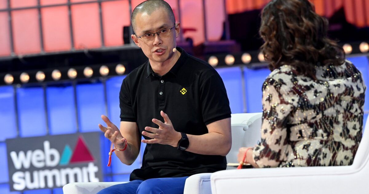 Changpeng Zhao speaking at Web Summit with a Binance logo on his shirt