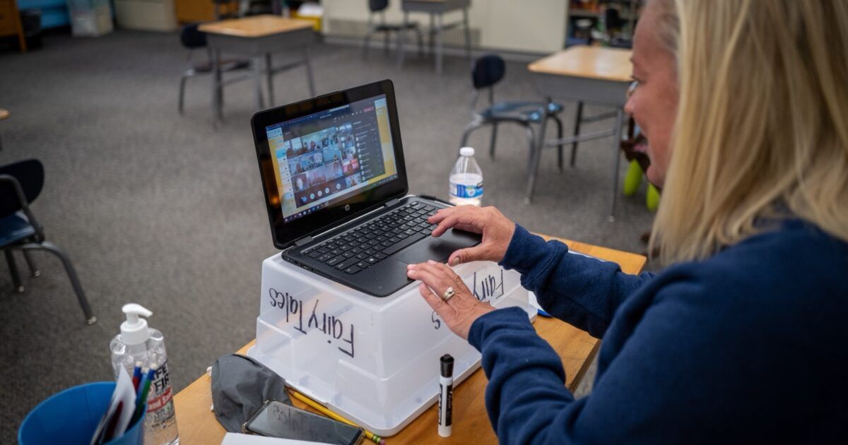 Teacher using a laptop for an online meeting, illustrating BlueNoroff’s fake meeting campaign