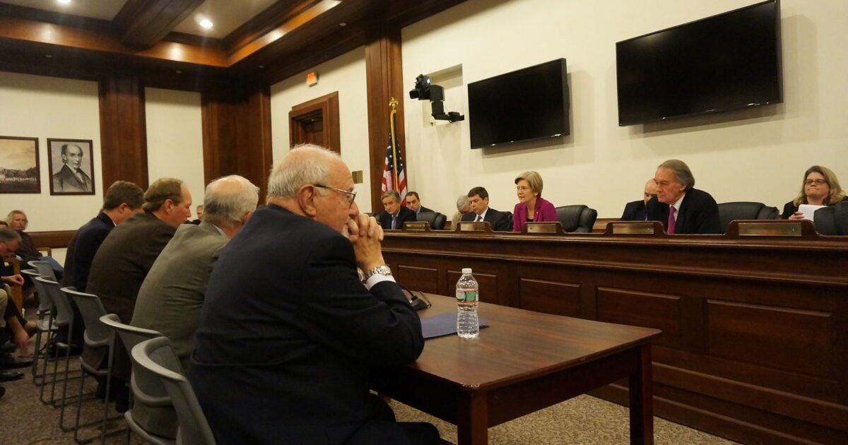 Senator Elizabeth Warren seated at the dais during a Senate Banking Committee hearing.