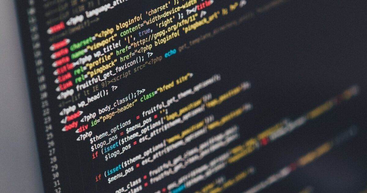 Colorful source code on a computer screen for a ProCoinNews article about the Ill Bloom wallet recovery phrase vulnerability.