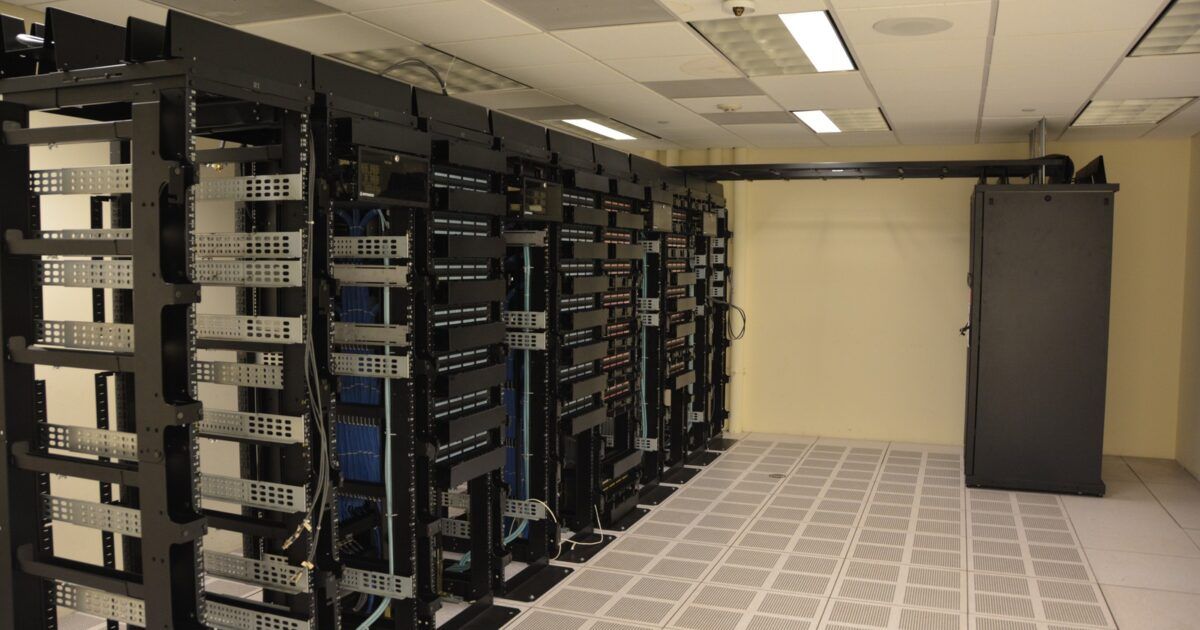 Rows of illuminated server racks inside a data center