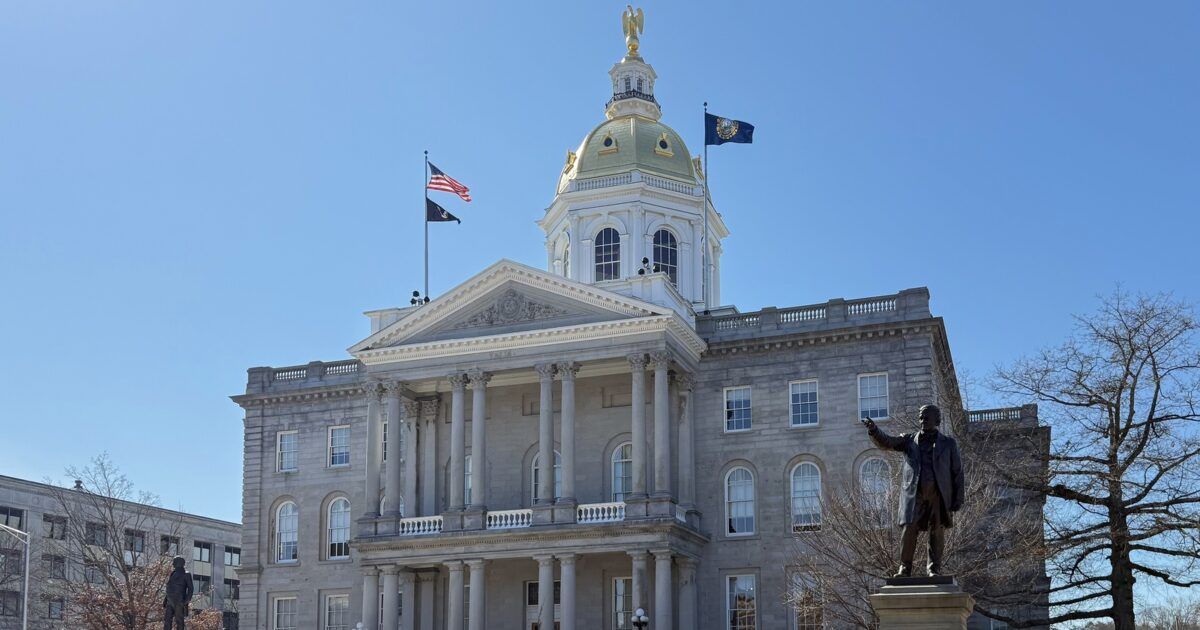 New Hampshire State House in Concord under a clear blue sky