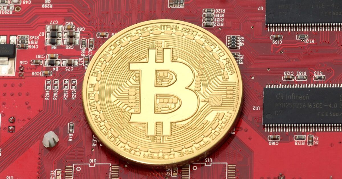 Physical Bitcoin on a red circuit board